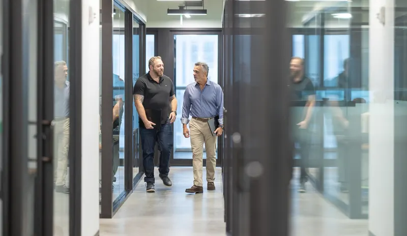 Three of the team walking the corridor